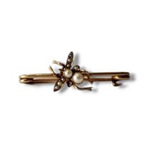 AN EARLY 20TH CENTURY YELLOW METAL AND SEED PEARL INSECT BROOCH Dragonfly set with graduated pearls.