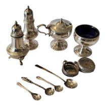 A VINTAGE SILVER AND BLUE GLASS CRUET SET Three piece comprising a pepperette, salt and mustard pot,