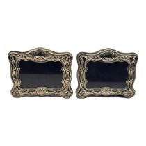 A PAIR OF 20TH CENTURY SILVER PHOTOGRAPH FRAMES Having scrolled embossed decoration, hallmarked