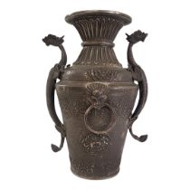 A LARGE 19TH CENTURY ASIAN WHITE METAL DRAGON VASE Twin dragon handles, with masked mounts and