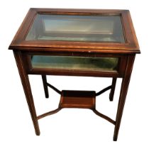 A LATE VICTORIAN MAHOGANY AND LINE INLAID BIJOUTERIE TABLE With bevelled glazed top, on square