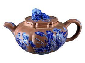 A CHINESE YIXING CLAY TEAPOT WITH BLUE ENAMELLED DECORATION Showing blue floral decoration and Dog