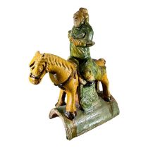 A 19TH CENTURY CHINESE QING DYNASTY SANCAI GLAZED EQUESTRIAN ROOF TILE Showing a man on horseback in