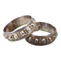 A PAIR OF LATE 19TH/EARLY 20TH CENTURY OMANI SILVER FERTILITY BRACLETS (BANAGIRI BU NUJUM/BANAGIRI