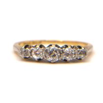 A VINTAGE 18CT YELLOW GOLD AND PLATINUM FIVE STONE DIAMOND RING The graduated row of old European