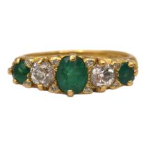 A VINTAGE 18CT YELLOW GOLD, FIVE STONE DIAMOND & EMERALD RING The central oval cut emerald (