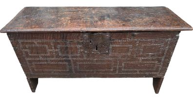 A SMALL 17TH CENTURY OAK COFFER With hinge lid above a carved panel. (h 48cm x d 35cm x w 90.5cm)
