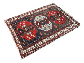 LORI PAMBAK KAZAK RUG Having blue field with central light blue and red octagonal medallion flanke