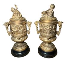 A PAIR OF FRENCH REGENCY DESIGN GILDED BRONZE LIDDED URNS Decorated with Neoclassical scenes,