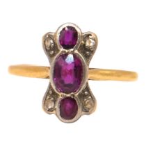 A 20TH CENTURY YELLOW METAL, RUBY AND DIAMOND RING Having three oval cut rubies (largest approx. 5mm