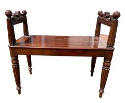 IN THE MANNER OF GEORGE BULLOCK, AN EARLY 19TH CENTURY REGENCY CARVED MAHOGANY WINDOW SEAT/BENCH