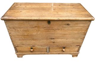 A 19TH CENTURY STRIP AND WAXED PINE MULE CHEST With hinged lid above two drawers, raised on