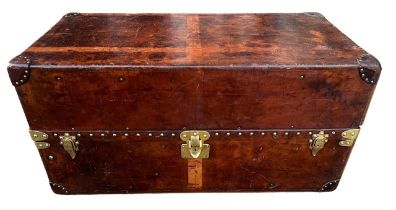 LOUIS VUITTON, AN EARLY 20TH CENTURY LEATHER AND BRASS BOUND STUDDED TRAVEL TRUNK. Retailed by