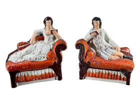 PAIR OF 19TH CENTURY BRITISH STAFFORDSHIRE BOOKENDS, POLYCHROMED, IN THE FORM OF A BOY AND GIRL