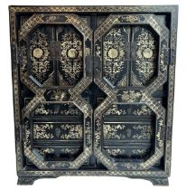 A CHINESE BLACK LACQUERED AND GILT PAINTED TABLE TOP CABINET The pair of doors opening to reveal