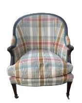 A GEORGE III MAHOGANY UPHOLSTERED ARMCHAIR The shaped back above padded scrolling arms and