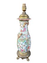 A 19TH CENTURY CHINESE CANTON FAMILLE ROSE PORCELAIN LAMP ON STYLISED GILT ORMOLU BASE Ground