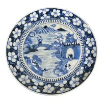 A 19TH CENTURY CHINESE QING BLUE AND WHITE PLATE Decorated with river landscape scene showing