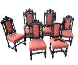 A SET OF SIX JACOBEAN DESIGN CARVED OAK DINING CHAIRS The backs decorated with lions scrolling