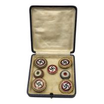 A COLLECTION OF FOUR WWII GERMAN NATIONAL SOCIALIST ENAMEL BADGES Red white and black enamel