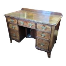 AN EARLY VICTORIAN SOLID MAHOGANY KNEEHOLE DESK Having an arrangement of seven drawers fitted with