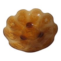 AN EARLY 20TH CENTURY AMBER GLASS BOWL Having a scalloped edge and embossed floral decoration to