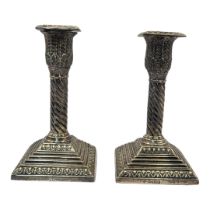 A PAIR OF VICTORIAN SILVER CANDLESTICKS Acanthus leaf decoration,flutes to column and stepped