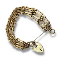 A VINTAGE 9CT GOLD GATE BRACELET Five pierced bars with heart form clasp. (approx 9cm) Condition:
