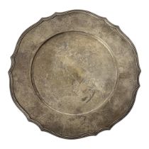 A VINTAGE STERLING SILVER CHARGER PLATE Having a scrolled edge with engraved decoration, marked to