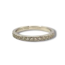 TIFFANY & CO., A PLATINUM AND DIAMOND FULL ETERNITY RING Having a row of round cut diamonds. (size