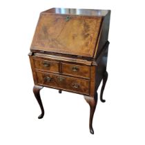 AN 18TH CENTURY DESIGN LADIES’ WALNUT WRITING BUREAU The fall front enclosing a fitted interior