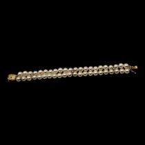 MIKIMOTO, AN 18CT GOLD, DIAMOND AND PEARL BRACELET Two rows of cultured Pearl's,interspersed with