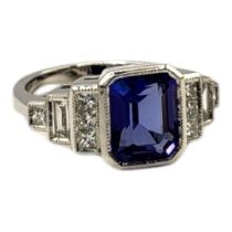 AN 18CT WHITE GOLD, TANZANITE AND DIAMOND RING The central octagonal cut tanzanite edged with