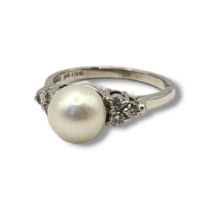 AN 18CT WHITE GOLD, DIAMOND AND CULTURED PEARL RING The single cultured pearl flanked by round cut