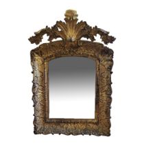 AN EARLY 19TH CENTURY CONTINENTAL CARVED GILTWOOD ROCOCO STYLE WALL MIRROR (POSSIBLY ITALIAN) The