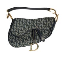 CHRITIAN DIOR, A VINTAGE LEATHER AND CANVAS SADDLE BAG Blue leather strap with gilt attachments