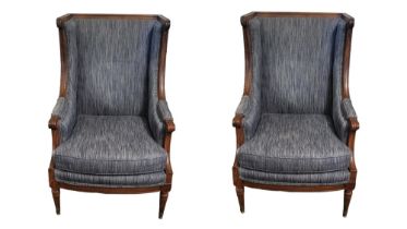 A PAIR OF LATE 19TH CENTURY FRENCH WALNUT FRAMED WING ARMCHAIRS In later blue fabric upholstery on