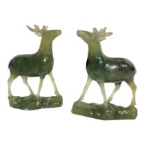 A PAIR OF ORIENTAL SPINACH GREEN JADE CARVINGS OF STAGS Carved and modelled in relief, with