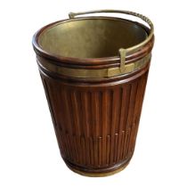 A GEORGIAN STYLE IRISH MAHOGANY PEAT BUCKET With rope twist brass handle, liner and bandings. (