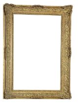 AN EARLY 20TH CENTURY GILDED RECTANGULAR PICTURE FRAME With carved scrolled decoration. (aperture