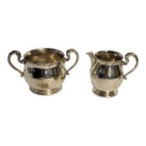 AN EDWARDIAN SILVER SUGAR BASIN AND CREAM JUG Twin handles with baluster form base, hallmarked