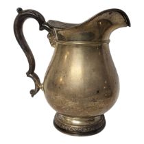 A VINTAGE AMERICAN STERLING SILVER WATER JUG Having a single handle and baluster body, marked to