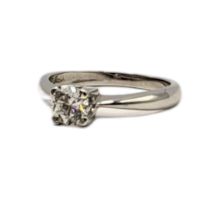 AN 18CT WHITE GOLD AND DIAMOND SOLITAIRE RING Having a single round cut diamond. (approx diamond
