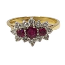 AN 19CT GOLD, RUBY AND DIAMOND CLUSTER RING The row of three graduated round cut rubies edged with