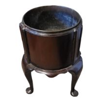 A 19TH CENTURY SOLID MAHOGANY CIRCULAR WINE COOLER Ribbed body with brass liner above shaped apron