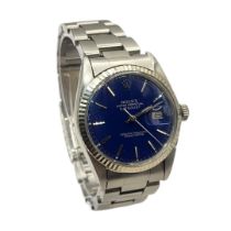 ROLEX, DATEJUST, A VINTAGE STAINLESS STEEL GENT’S WRISTWATCH Having an 18ct white gold bezel, blue