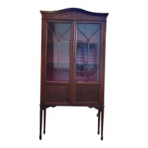 AN EDWARDIAN MAHOGANY AND FLORAL DECORATED TWO DOOR DISPLAY CABINET On square tapering legs. (92cm x
