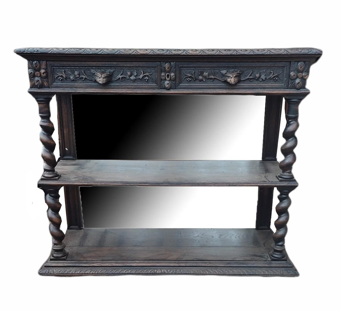 A VICTORIAN OAK OPEN SIDE SHELVES With mirrored back and top above two carved drawers, on heavy
