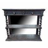 A VICTORIAN OAK OPEN SIDE SHELVES With mirrored back and top above two carved drawers, on heavy