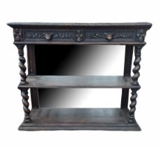 A VICTORIAN OAK OPEN SIDE SHELVES With mirrored back and top above two carved drawers, on heavy